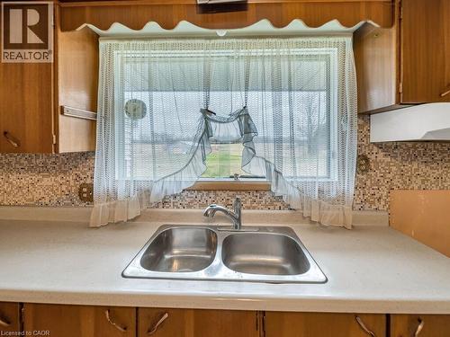 Dual basin stainless steel sink with a chrome faucet set against a light-toned countertop - 1416 Highway 6, Hamilton, ON - Indoor Photo Showing Kitchen With Double Sink