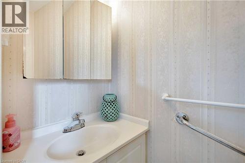 Bathroom vanity with an integrated sink, polished chrome faucet, and a wall-mounted medicine cabinet - 32 Montclair Crescent, Simcoe, ON - Indoor Photo Showing Bathroom