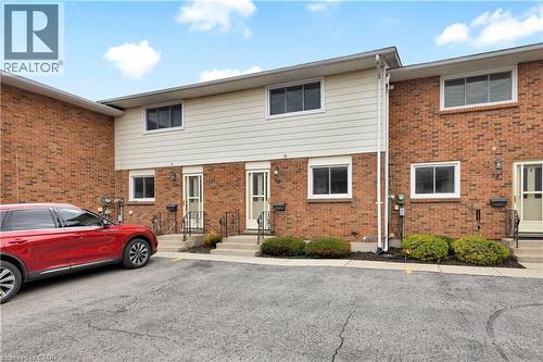 Brick and siding exterior featuring white frame windows and individual front entrances - 32 Montclair Crescent, Simcoe, ON - Outdoor With Exterior
