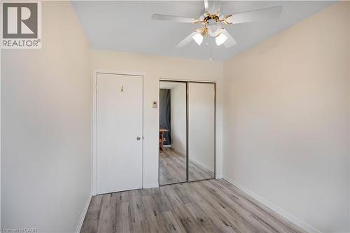Interior room featuring light-toned walls, wood-finish flooring, and a ceiling fan with integrated lighting - 32 Montclair Crescent, Simcoe, ON - Indoor Photo Showing Other Room