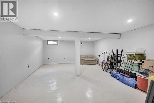 Spacious lower level featuring light-colored flooring, recessed lighting, painted walls, and a single window offering natural light - 32 Montclair Crescent, Simcoe, ON - Indoor Photo Showing Basement
