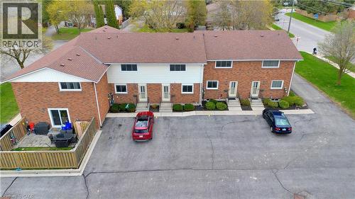 Brick exterior townhome with private fenced patio, individual entranceways, and dedicated parking - 32 Montclair Crescent, Simcoe, ON - Outdoor