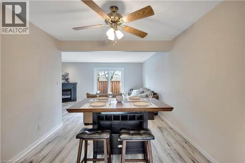 Dining area featuring wood-finish flooring and a ceiling fan with light fixture - 32 Montclair Crescent, Simcoe, ON - Indoor