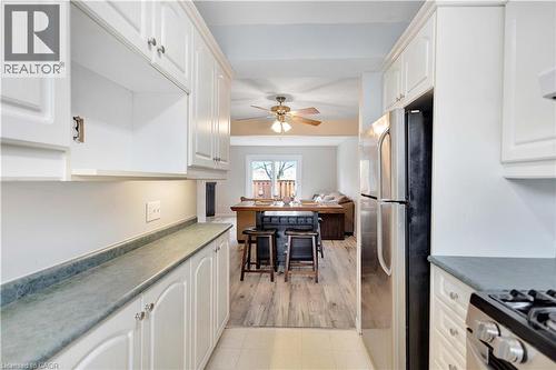 Galley kitchen featuring white cabinetry and light-toned countertops - 32 Montclair Crescent, Simcoe, ON - Indoor Photo Showing Kitchen