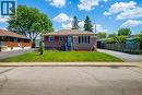 Single-story residence featuring a brick facade with stone accents, a covered front porch with a white railing, and a sloped roof - 103 East 45Th Street, Hamilton, ON  - Outdoor 