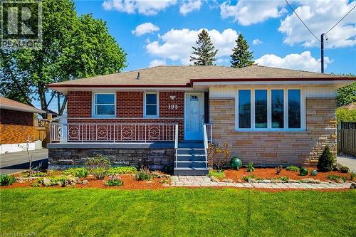 Brick and stone veneer exterior featuring multiple windows and a covered front porch - 103 East 45Th Street, Hamilton, ON - Outdoor With Deck Patio Veranda