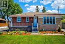 Brick and stone veneer exterior featuring multiple windows and a covered front porch - 103 East 45Th Street, Hamilton, ON  - Outdoor With Deck Patio Veranda 