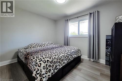 Neutral wall tones complement the wood-finish flooring in this room - 103 East 45Th Street, Hamilton, ON - Indoor Photo Showing Bedroom