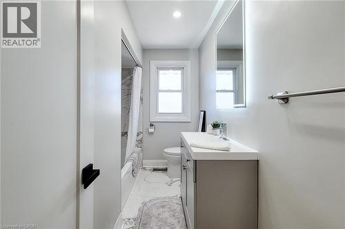 Modern bathroom featuring a contemporary vanity with a white countertop and gray cabinetry - 103 East 45Th Street, Hamilton, ON - Indoor Photo Showing Bathroom