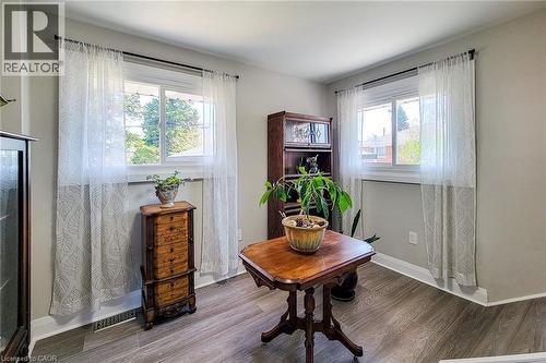 Room featuring two white-framed windows, light gray wall paint, and wood-finish flooring - 103 East 45Th Street, Hamilton, ON - Indoor