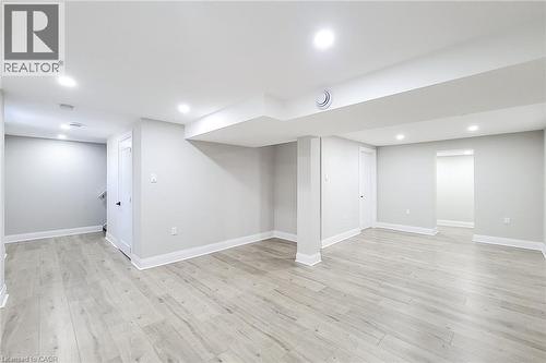 Spacious lower level featuring wood-finish flooring, recessed lighting, neutral wall tones, white trim, and architectural columns - 103 East 45Th Street, Hamilton, ON - Indoor