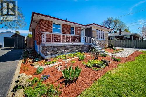 Brick and stone facade featuring a front porch with decorative railing - 103 East 45Th Street, Hamilton, ON - Outdoor With Deck Patio Veranda