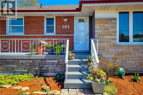 Front exterior featuring red brick and stacked stone siding - 103 East 45Th Street, Hamilton, ON - Outdoor