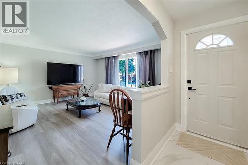 Entryway featuring a decorative transom window above the door, a half-wall partition, and wood-finish flooring - 103 East 45Th Street, Hamilton, ON - Indoor