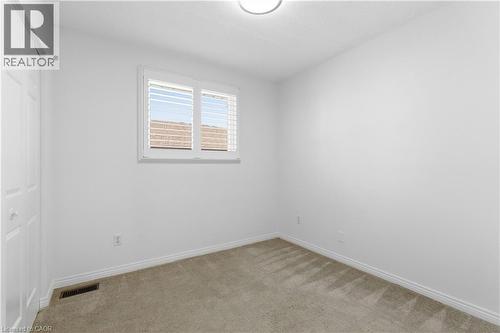 Neutral-toned carpeting paired with white baseboards and walls - 341 Rexford Drive, Hamilton, ON - Indoor Photo Showing Other Room