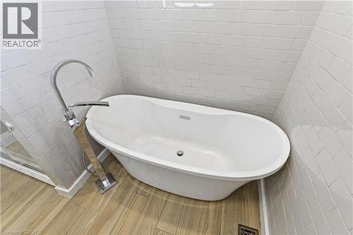 Freestanding soaking tub featuring a chrome floor-mounted filler - 341 Rexford Drive, Hamilton, ON - Indoor Photo Showing Bathroom