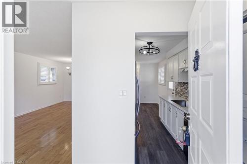 Entryway featuring a white paneled door with a decorative knocker - 341 Rexford Drive, Hamilton, ON - Indoor