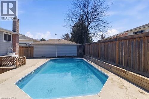 Rectangular inground pool with concrete surround - 341 Rexford Drive, Hamilton, ON - Outdoor With In Ground Pool With Deck Patio Veranda