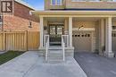 Brick and stone veneer facade with a covered front porch, dual front doors, an attached garage, and a concrete pathway - 9 Rabbit Run Way, Brampton, ON  - Outdoor 