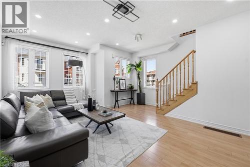 Inviting living area featuring light wood-finish flooring, recessed ceiling lighting, and multiple windows with white trim - 9 Rabbit Run Way, Brampton, ON - Indoor Photo Showing Living Room