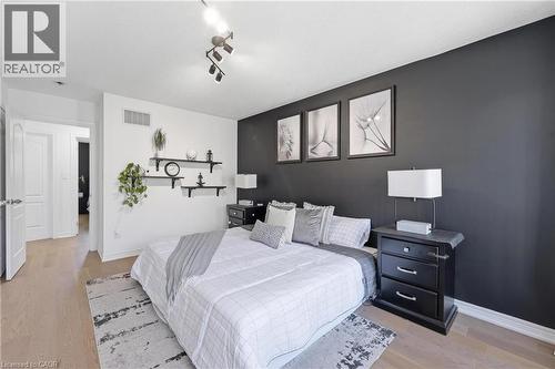 Bedroom featuring light wood-finish flooring and a contrasting accent wall - 9 Rabbit Run Way, Brampton, ON - Indoor Photo Showing Bedroom