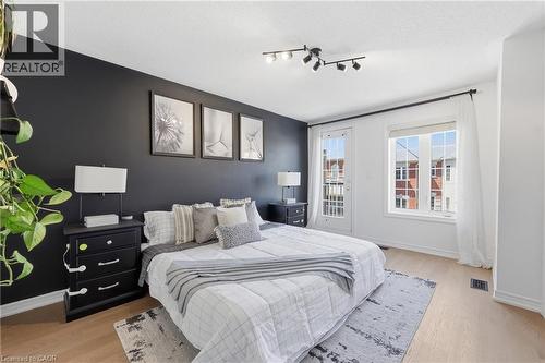 Bedroom featuring a dark accent wall, track lighting, and light wood-finish flooring - 9 Rabbit Run Way, Brampton, ON - Indoor Photo Showing Bedroom
