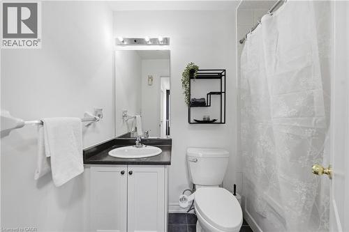 Bathroom featuring a white vanity with dark countertop, undermount sink, and chrome faucet - 9 Rabbit Run Way, Brampton, ON - Indoor Photo Showing Bathroom