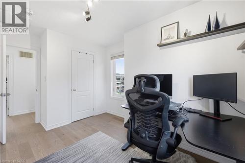 Bright room featuring light wood-finish flooring, white walls, a single window, and a built-in wall shelf - 9 Rabbit Run Way, Brampton, ON - Indoor Photo Showing Office