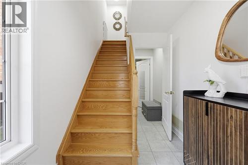Natural wood staircase with a matching wood handrail, contrasted by crisp white walls and trim - 9 Rabbit Run Way, Brampton, ON - Indoor Photo Showing Other Room