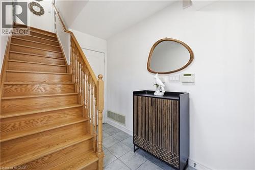 Hardwood staircase featuring a natural wood finish, baluster railing, and a coordinating newel post - 9 Rabbit Run Way, Brampton, ON - Indoor Photo Showing Other Room