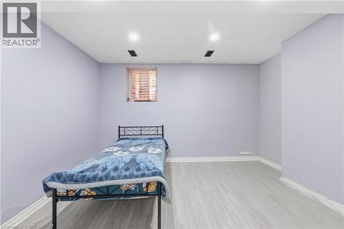 Room with light lavender walls, wood-finish flooring, white baseboards, and a single window with blinds - 9 Rabbit Run Way, Brampton, ON - Indoor