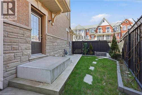 Stone veneer and brick exterior with a dark-paneled entry door - 9 Rabbit Run Way, Brampton, ON - Outdoor