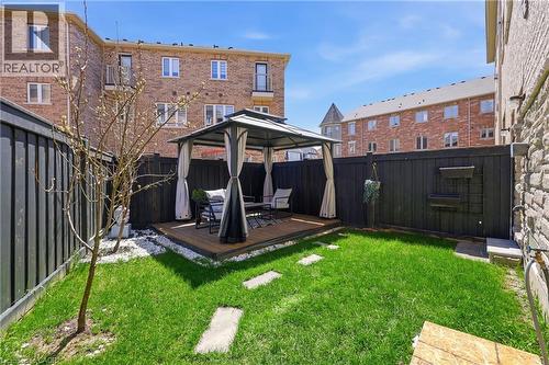 Private backyard featuring a gazebo on a raised deck, a manicured lawn, and stepping stones - 9 Rabbit Run Way, Brampton, ON - Outdoor With Deck Patio Veranda