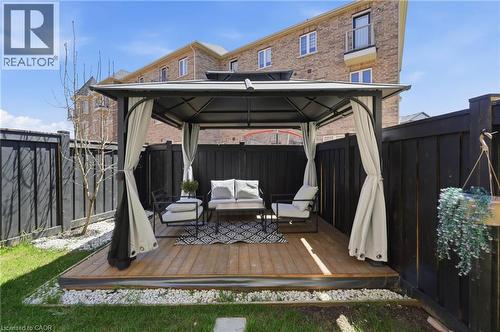Outdoor gazebo with a metal frame and privacy curtains, situated on a wood-finish deck - 9 Rabbit Run Way, Brampton, ON - Outdoor With Exterior