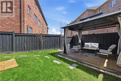 Outdoor gazebo with a wood-finish deck, surrounded by a manicured lawn - 9 Rabbit Run Way, Brampton, ON - Outdoor With Deck Patio Veranda