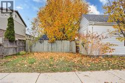Parking area at side of structure; established shrubbery, featuring existing outbuilding - 