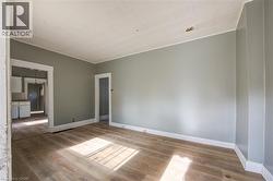 Spacious living  room featuring wood-finish flooring and neutral wall tones - 