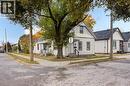 Corner lot property featuring a white siding exterior, a front porch with railing, and a gabled roof - 1 Rathgar Street, London, ON  - Outdoor 