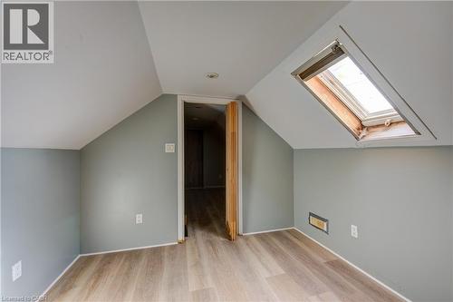 Bedroom 2 featuring a skylight, wood-finish flooring, recessed lighting, and sloped ceilings - 1 Rathgar Street, London, ON - Indoor Photo Showing Other Room