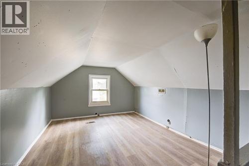 Bedroom 3 featuring wood-finish flooring, light blue and white painted walls, and a single window - 1 Rathgar Street, London, ON - Indoor Photo Showing Other Room