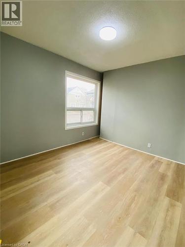 Unit 1A Living Room; Spacious room featuring light wood-finish flooring, neutral gray wall paint, and crisp white trim - 1 Rathgar Street, London, ON - Indoor Photo Showing Other Room