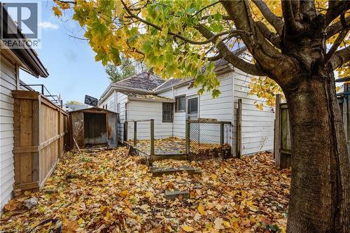 Rear exterior with white siding and a small wooden deck - 1 Rathgar Street, London, ON - Outdoor