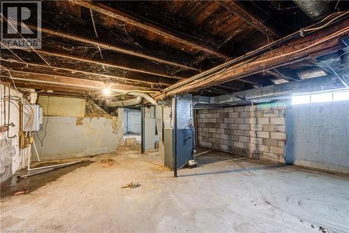 Lower level featuring concrete flooring, exposed wood ceiling joists, and a partial block wall - 1 Rathgar Street, London, ON - Indoor Photo Showing Basement