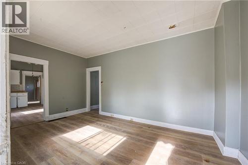 Spacious living  room featuring wood-finish flooring and neutral wall tones - 1 Rathgar Street, London, ON - Indoor Photo Showing Other Room