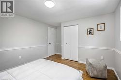 Hardwood flooring complemented by chair rail molding and neutral wall tones - 