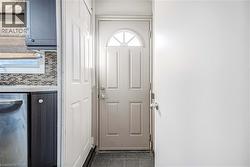 Entry door featuring an arched transom window - 