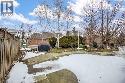 Spacious outdoor area featuring a concrete patio, mature trees, and a privacy fence - 85 Ranchdale Drive, Hamilton, ON - Outdoor