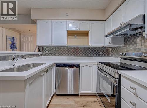 1490 Bishops Gate Unit# 106, Oakville, ON - Indoor Photo Showing Kitchen With Double Sink