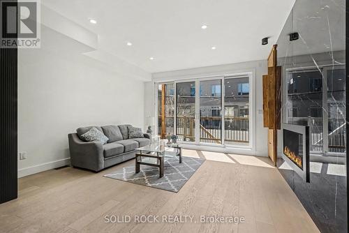 Family Room with Balcony - 826 Alpine Avenue, Ottawa, ON - Indoor With Fireplace