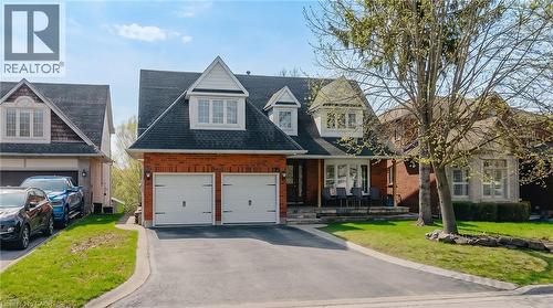 Brick-faced exterior with white trim accents and dark shingle roof - 79 Holbrook Crescent, Cambridge, ON - Outdoor With Facade